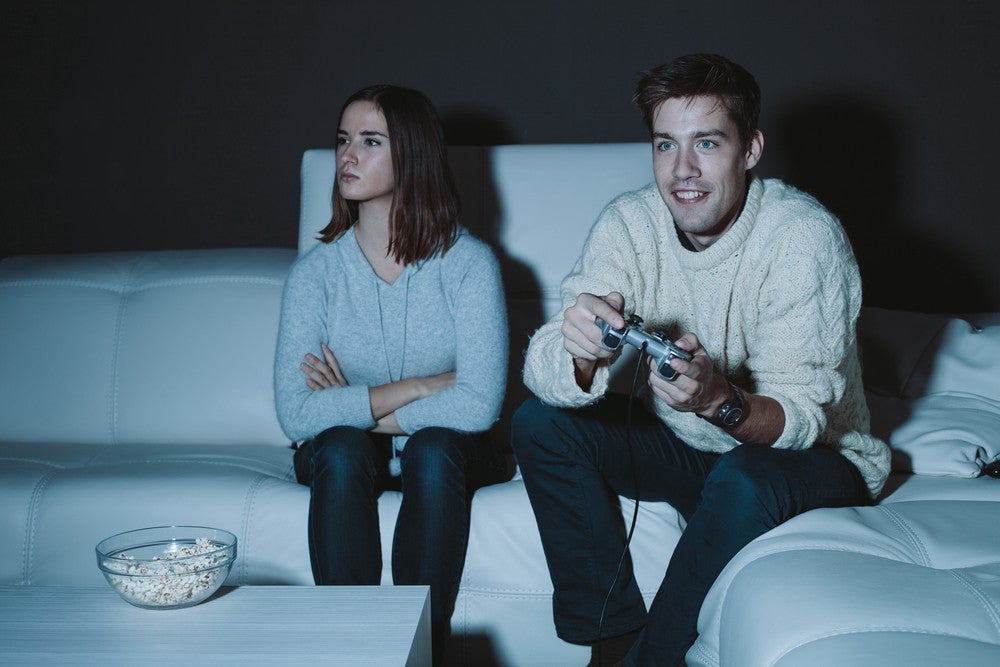 Boyfriend learning his girlfriend to play video games on