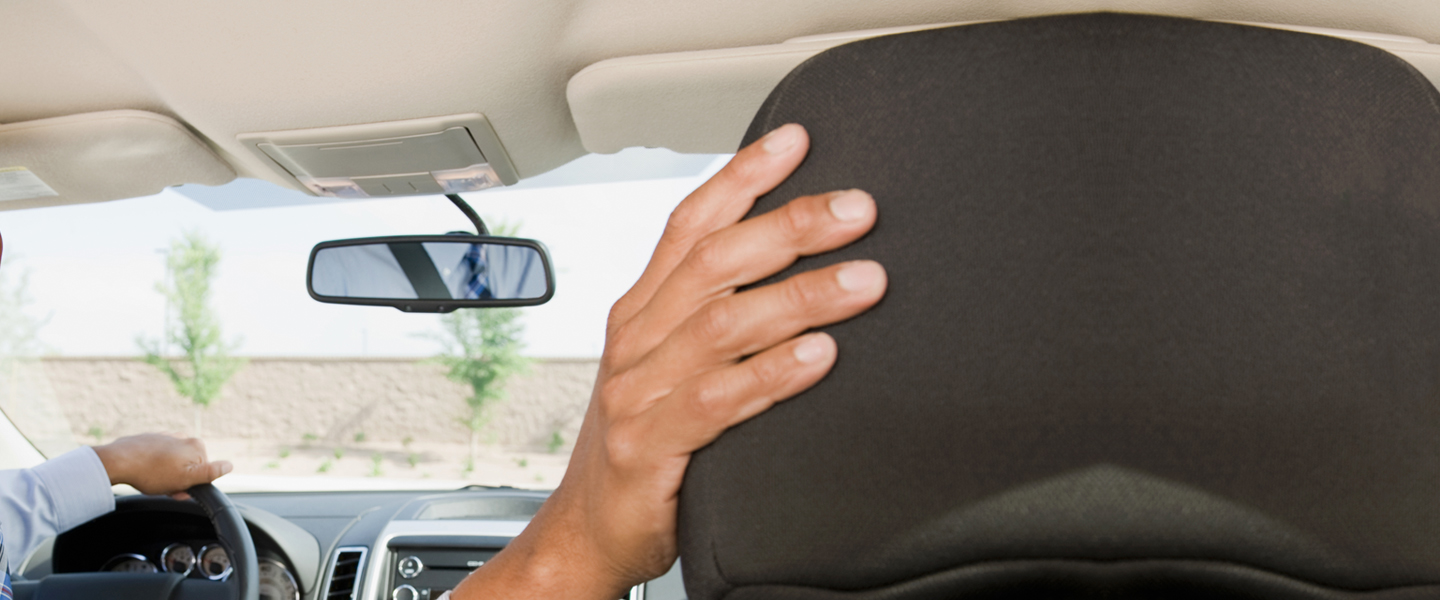 Should car seat go behind driver or passenger?