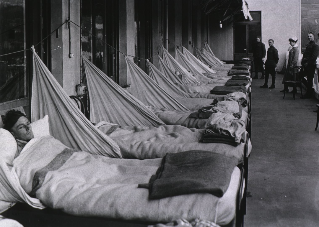 Disease names tied to geographic locations Patients suffering from Spanish flu lie in a ward full of beds